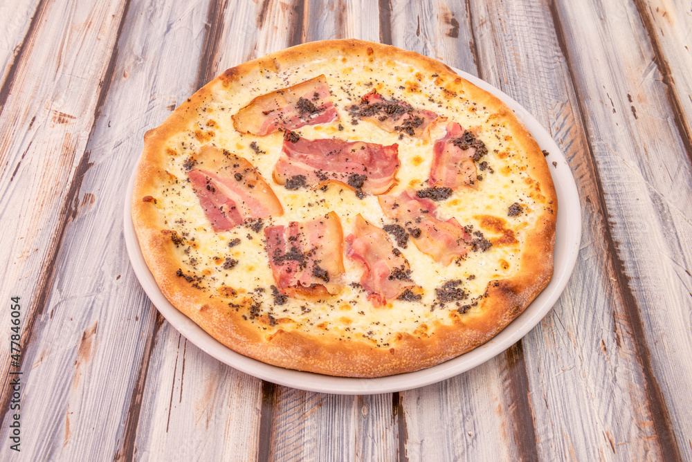 Pizza with lots of fried sliced bacon and truffle with mozzarella cheese and olive oil Pizza with lots of fried sliced bacon and truffle with mozzarella cheese and olive oil