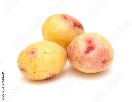 Small new potatoes with pink coloration isolated on white background 