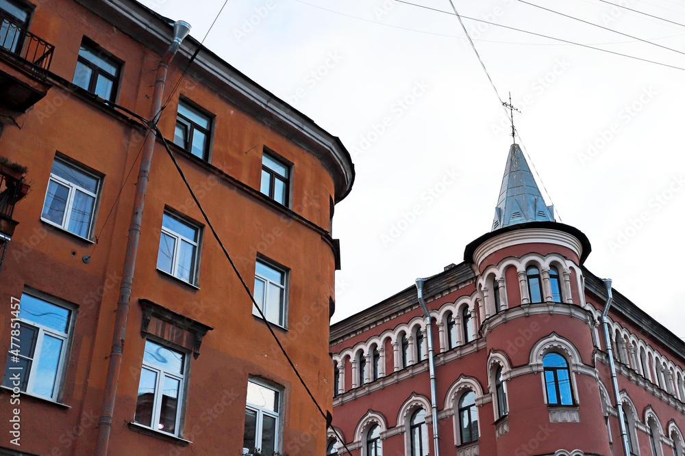 old buildings in a big European city are hung with wires and modern details