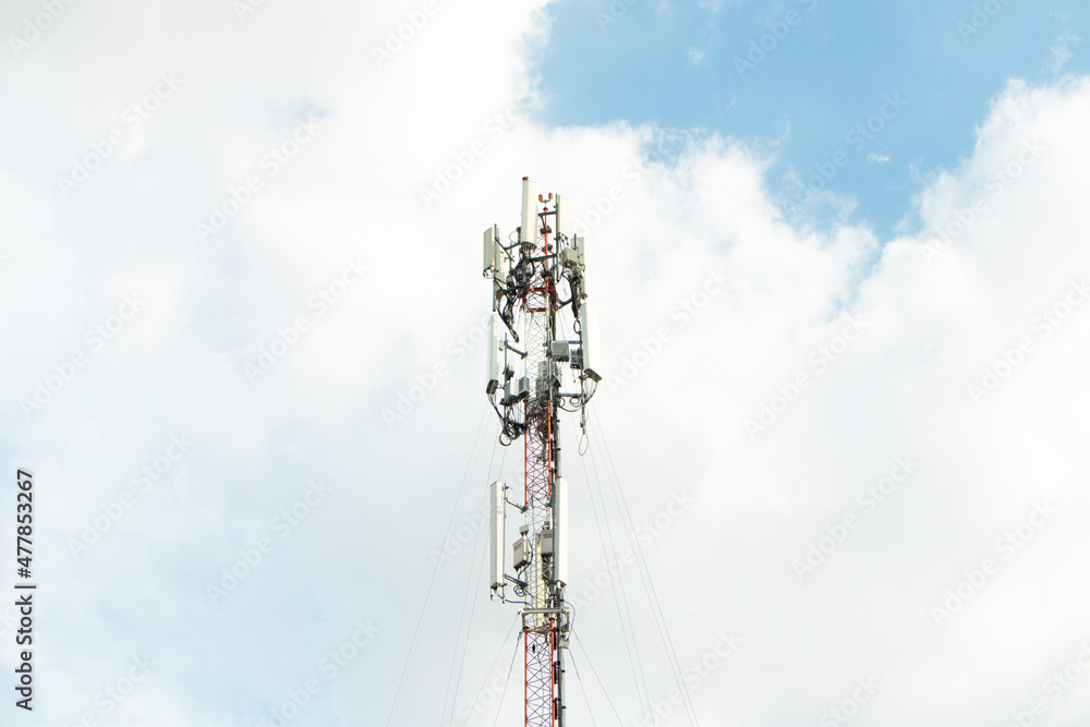 Communication tower telephone pole wireless communication technology. Telecommunication tower of 4G and 5G cellular. Smart antennas mounted on a metal against with dense clouds sky, is background.