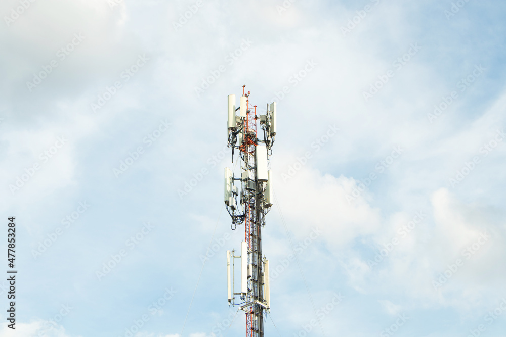 Communication tower telephone pole. Telecommunication tower of 4G and 5G cellular. Smart antennas mounted on a metal against with dense clouds sky background and bright sunlight in evening. Communication tower telephone pole. Telecommunication tower of 4G and 5G cellular. Smart antennas mounted on a metal against with dense clouds sky background and bright sunlight in evening.