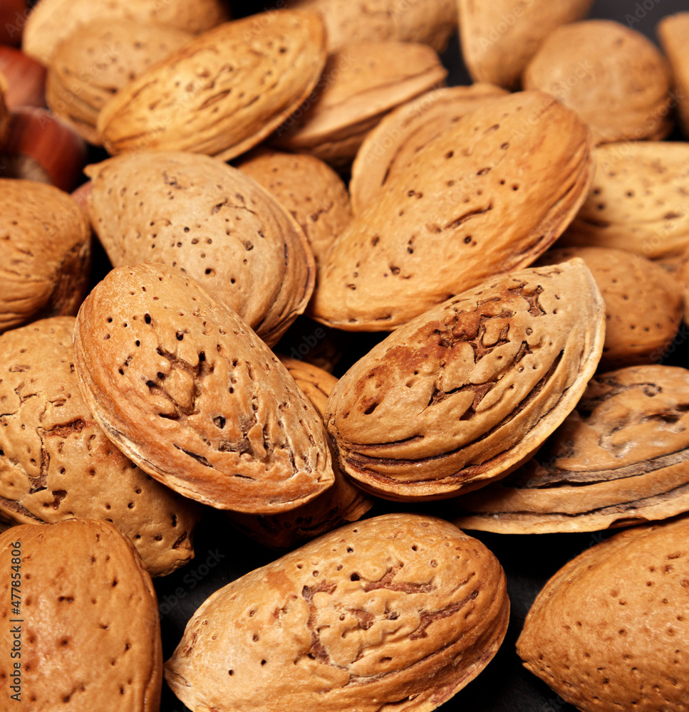 Almond nuts background. Almond with shell. Selective focus.