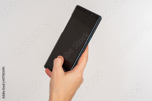 Female hand with phone. Mod...