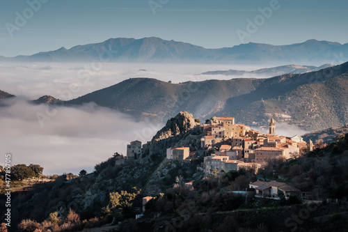 Mist hanging in the valley behind the ancient mountain village of Speloncato in the Balagne region of Corsica photo