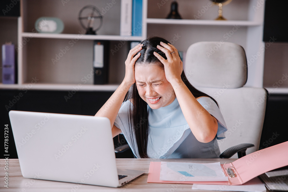 The boss is sitting at his desk showing stress from the company's problems. The boss is sitting at his desk showing stress from the company's problems.
