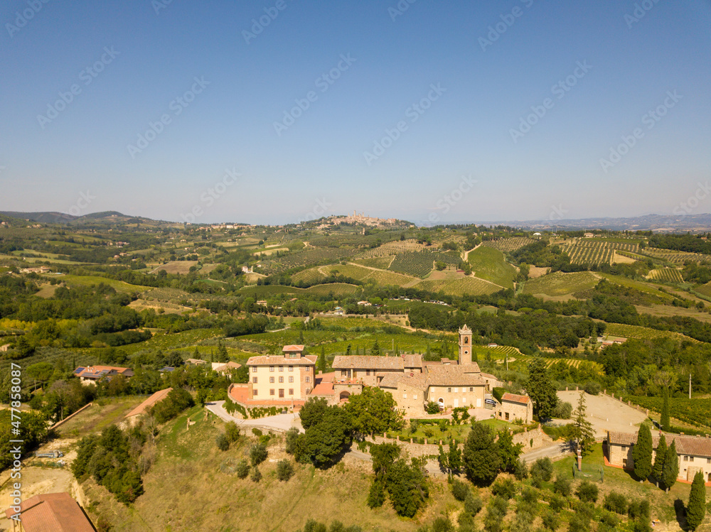 Aerial/Drone Panorama of Tuscany landscape with vineyards and olive trees - With Montauto castle and San Gimignano - Italy	