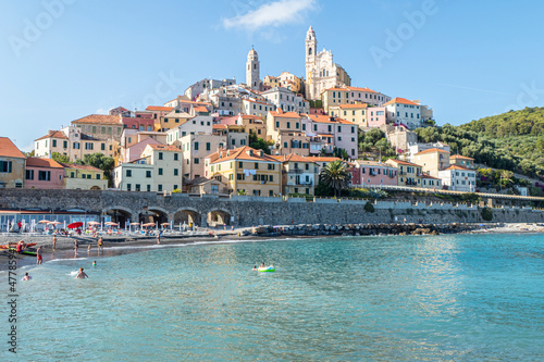 The beach of Cervo with his beautiful historic center in background photo