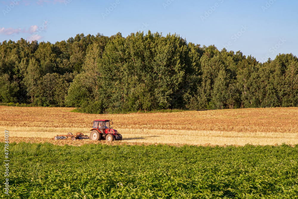tractor plowing a field on a clear day tractor plowing a field on a clear day