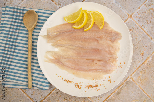 Fototapeta raw flounder fillet in a plate