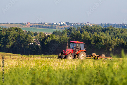 tractor plowing a field on a clear day. view of the horizon