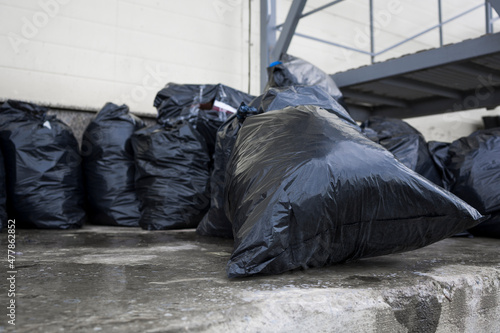Black plastic garbage bags placed in Garbage Disposal Site at shopping mall