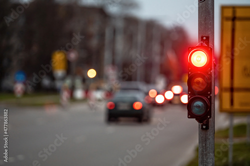 traffic light on the street junction with beautiful bokeh, city with cars in the background