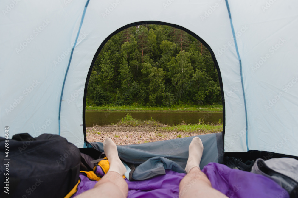 First-person view of the river bank from the tent.