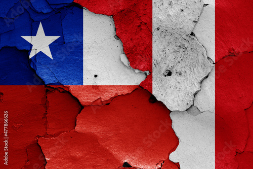 flags of Chile and Peru painted on cracked wall