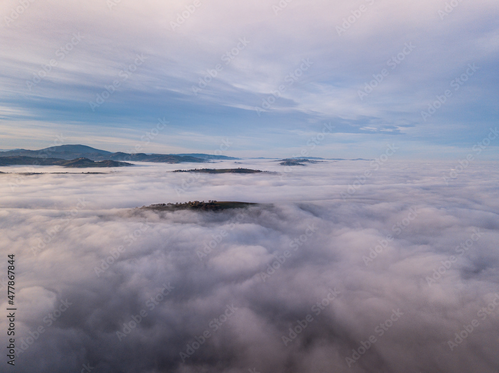 aerial view of landscape surrounded by fog
