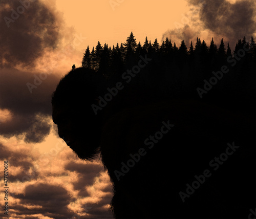 Illustration of a Bigfoot sasquatch creature stylized as the landscape with lone figure stood upon it against a dramatic sky