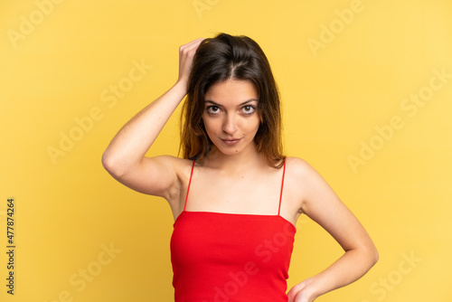 Young caucasian woman isolated on yellow background with an expression of frustration and not understanding