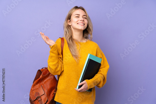 Teenager Russian student girl isolated on purple background smiling a lot