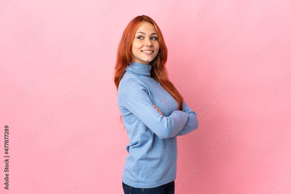 Teenager Russian girl isolated on pink background with arms crossed and happy Teenager Russian girl isolated on pink background with arms crossed and happy