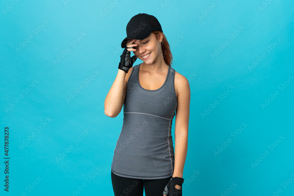 Teenager sport russian girl isolated on blue background laughing Teenager sport russian girl isolated on blue background laughing