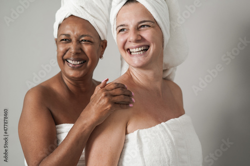 Happy multiracial senior women having fun together at beauty day - Self love and skin care treatment