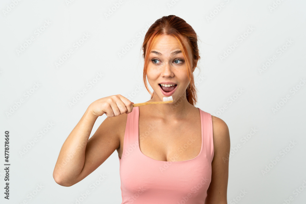 Teenager Russian girl isolated on white background with a toothbrush Teenager Russian girl isolated on white background with a toothbrush