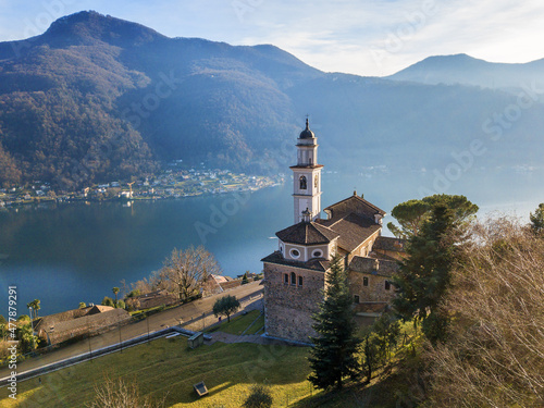 Aerial image of the parish church SS. Fedele e Simone istands on the high hill of Vico Morcote. Morcote at the Lake Lugano was once credited as one of the most beautiful Swiss villages. photo