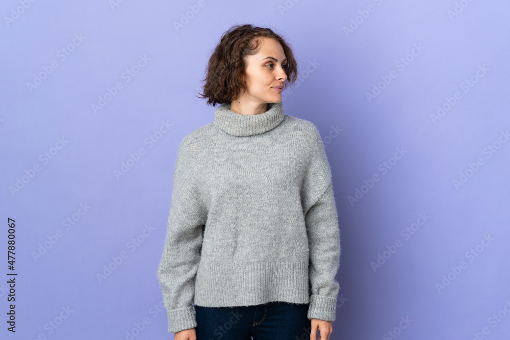Young English woman isolated on purple background looking to the side Young English woman isolated on purple background looking to the side