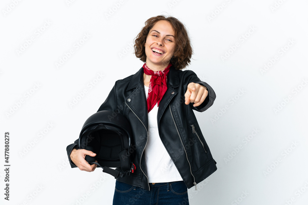 English woman holding a motorcycle helmet isolated on white background pointing front with happy expression English woman holding a motorcycle helmet isolated on white background pointing front with happy expression