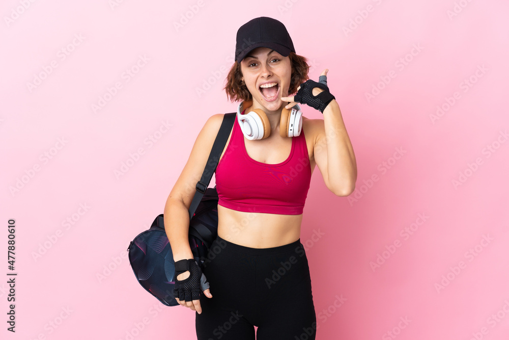 Young sport woman with sport bag over isolated background making phone gesture. Call me back sign Young sport woman with sport bag over isolated background making phone gesture. Call me back sign
