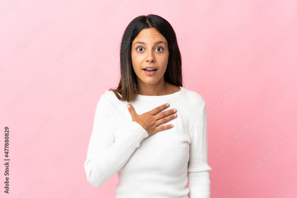 Caucasian girl isolated on pink background surprised and shocked while looking right Caucasian girl isolated on pink background surprised and shocked while looking right