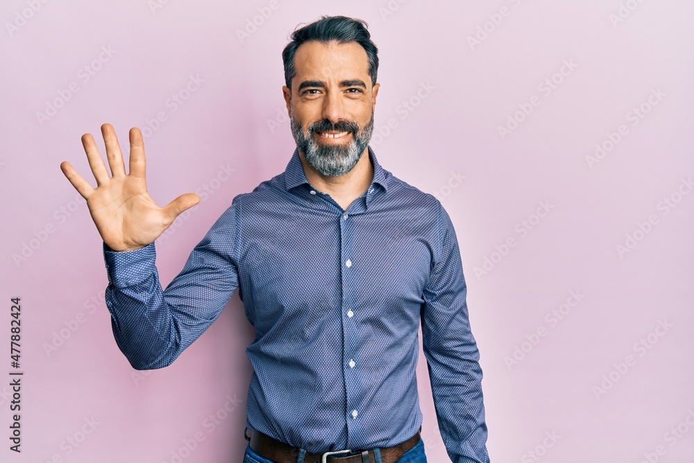 Middle age man with beard and grey hair wearing business clothes showing and pointing up with fingers number five while smiling confident and happy. Middle age man with beard and grey hair wearing business clothes showing and pointing up with fingers number five while smiling confident and happy.