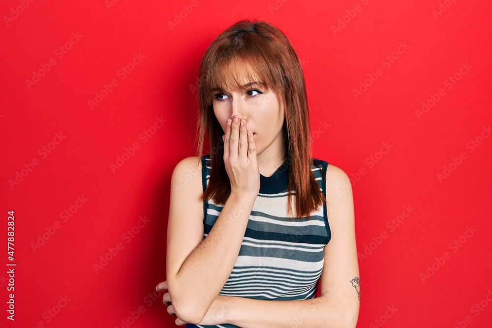 Redhead young woman wearing casual t shirt bored yawning tired covering mouth with hand. restless and sleepiness. Redhead young woman wearing casual t shirt bored yawning tired covering mouth with hand. restless and sleepiness.