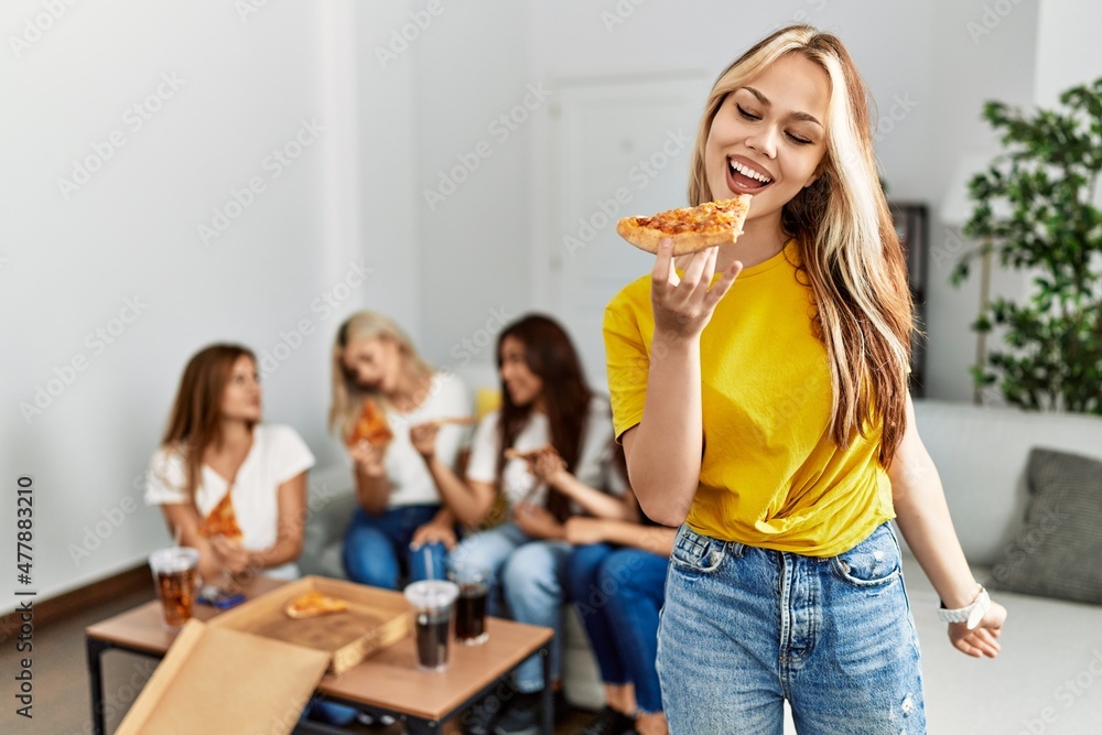 Group of young woman friends smiling happy eating pizza at home. Group of young woman friends smiling happy eating pizza at home.