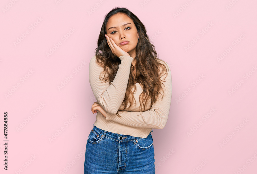 Young hispanic girl wearing casual clothes thinking looking tired and bored with depression problems with crossed arms. Young hispanic girl wearing casual clothes thinking looking tired and bored with depression problems with crossed arms.