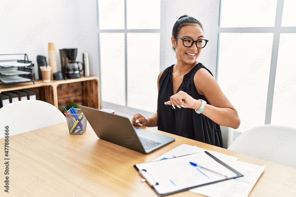 Young latin woman smiling confident looking watch at office Young latin woman smiling confident looking watch at office