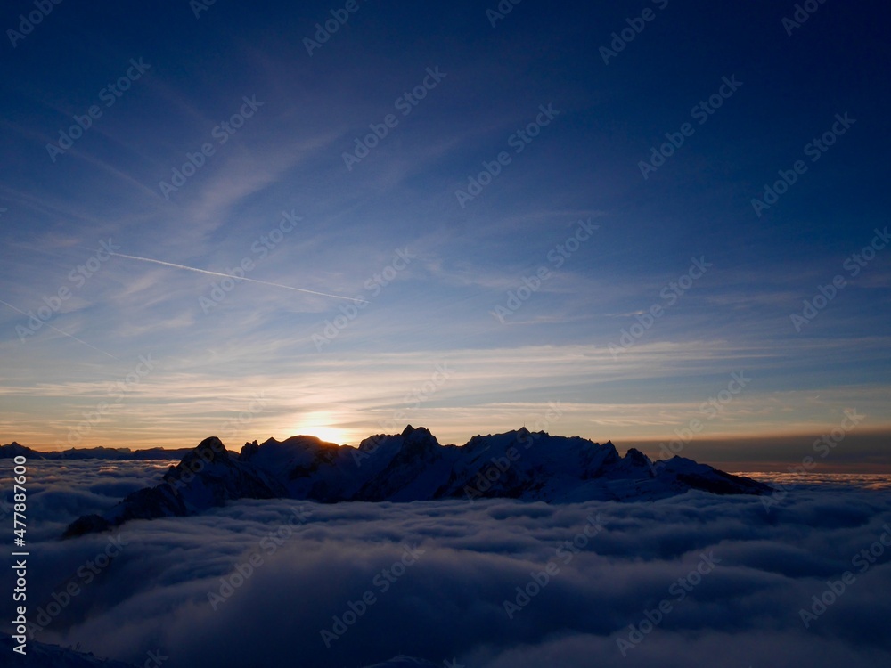 Spectacular view of Alpstein and fog blanket at sunset in winter seen from the mountain station of Hoher Kasten cable car. Appenzell, Switzerland. 