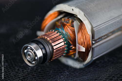 Fotografija Rotor and stator detail of electric DC motor on black mesh background