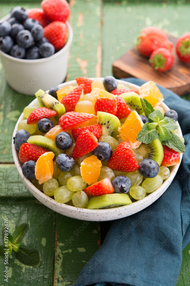 Fresh fruit salad, blueberries, strawberries, grapes, kiwi, orange.