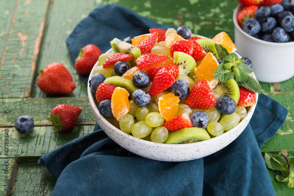 Fresh fruit salad, blueberries, strawberries, grapes, kiwi, orange.