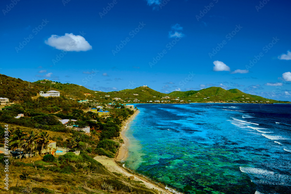 View of the ocean with colorful reefs and sand