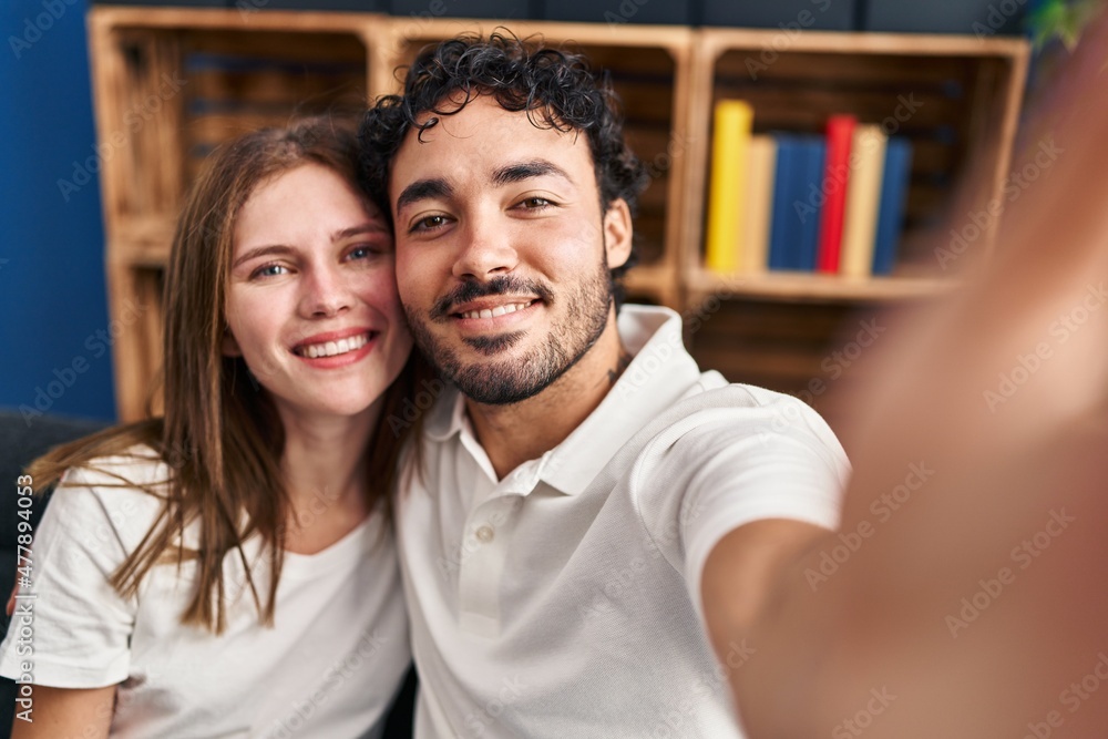 Man and woman hugging each other make selfie by the smartphone at home Man and woman hugging each other make selfie by the smartphone at home