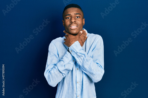 Young african american man wearing casual clothes shouting and suffocate because painful strangle. health problem. asphyxiate and suicide concept.