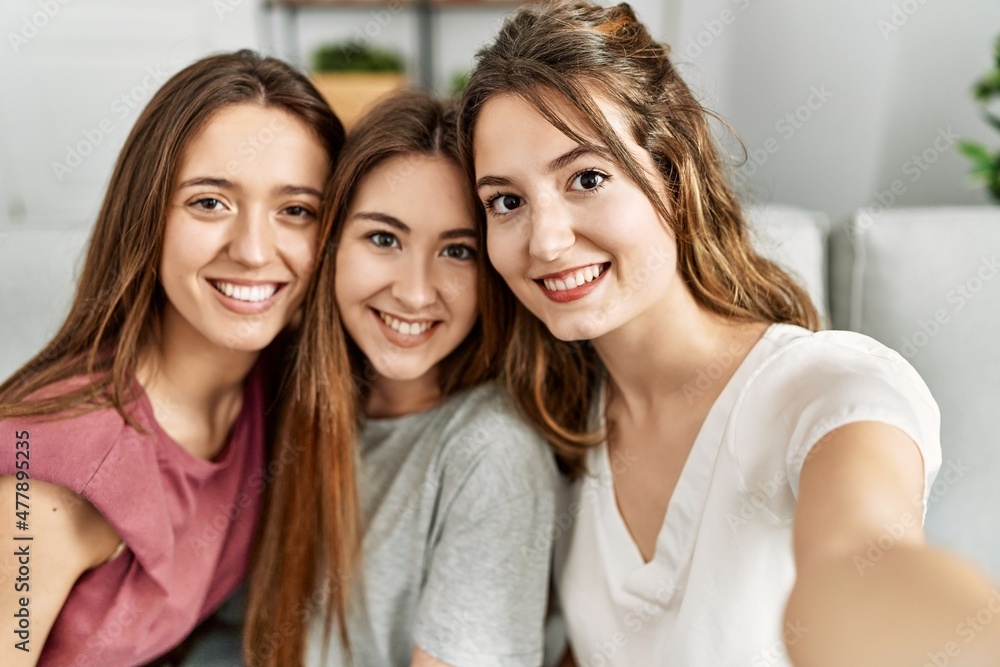 Three young hispanic woman smiling happy and make selfie by the smartphone sitting on the sofa at home. Three young hispanic woman smiling happy and make selfie by the smartphone sitting on the sofa at home.