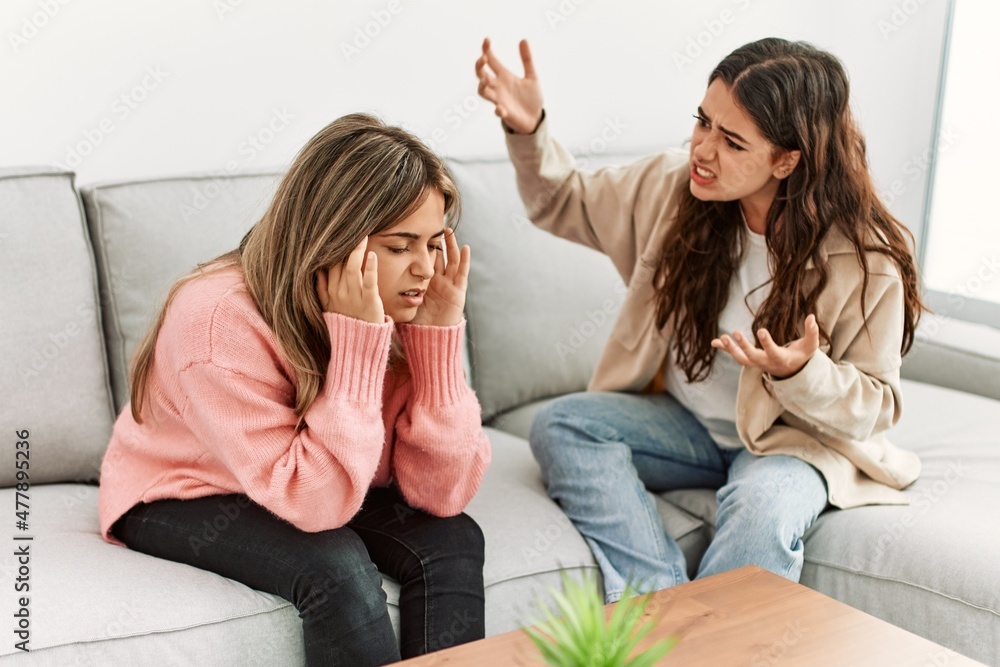 Young couple sitting on the sofa discussing at home. Young couple sitting on the sofa discussing at home.