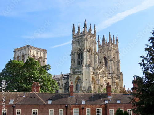 York Minster cathedral towers over roofs of old red brick houses
