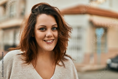 Young irish plus size girl smiling happy standing at the city.