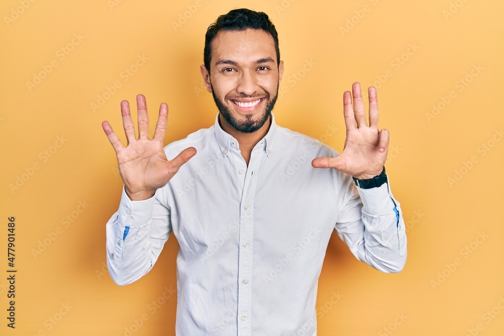 Hispanic man with beard wearing business shirt showing and pointing up with fingers number nine while smiling confident and happy. Hispanic man with beard wearing business shirt showing and pointing up with fingers number nine while smiling confident and happy.