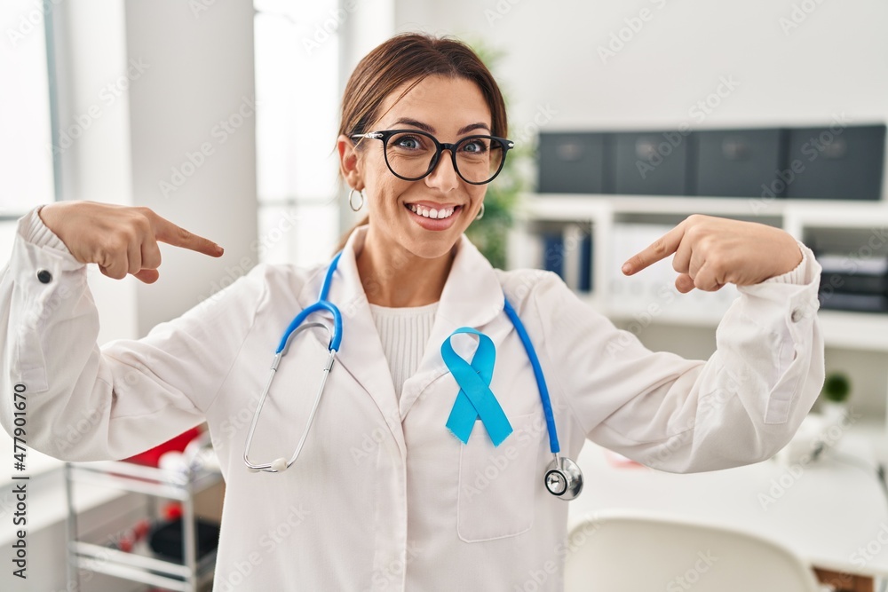 Young brunette doctor woman wearing stethoscope at the clinic looking confident with smile on face, pointing oneself with fingers proud and happy. Young brunette doctor woman wearing stethoscope at the clinic looking confident with smile on face, pointing oneself with fingers proud and happy.