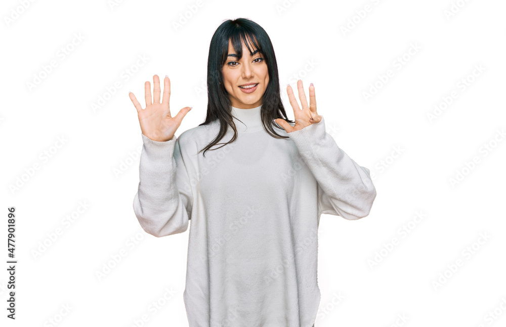Young brunette woman with bangs wearing casual turtleneck sweater showing and pointing up with fingers number nine while smiling confident and happy. Young brunette woman with bangs wearing casual turtleneck sweater showing and pointing up with fingers number nine while smiling confident and happy.